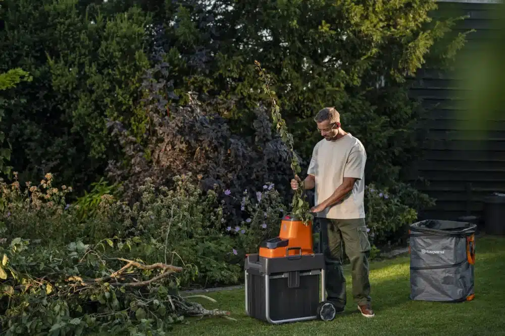 a man with headphones and a tool box in a yard