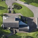 a house with a driveway and grass