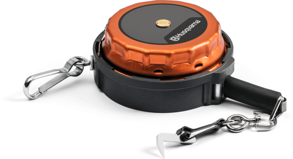 Retractable guide wire holder with Husqvarna branding.